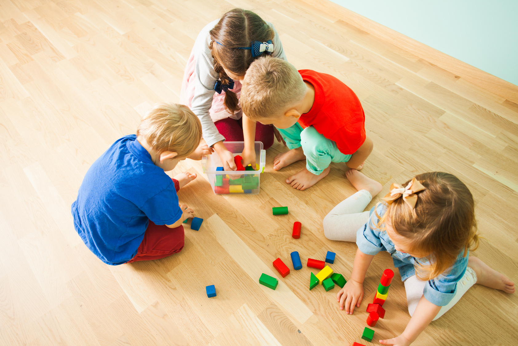 Children at Day Care Centre Putting Toys into Box